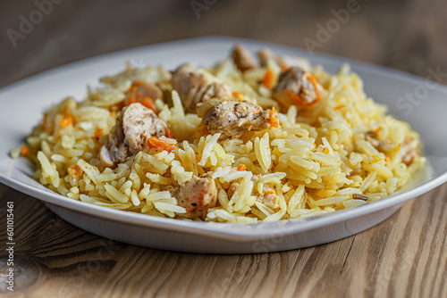 cooked at home hot delicious spicy pilaf with chicken on a white plate