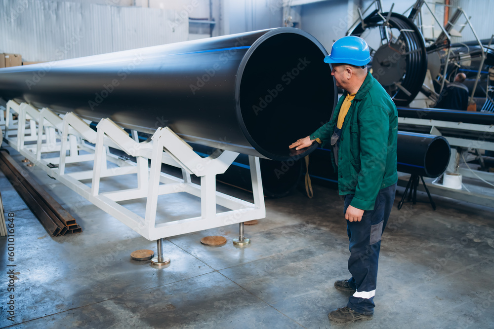 A man checking water pipes for defects A man checking water pipes for defects