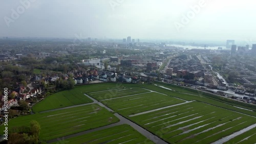 Green Fields With Water Canals On The Bank Of Zijkanaal I In North Amsterdam Near City Center And IJ River In The Netherlands. wide aerial photo