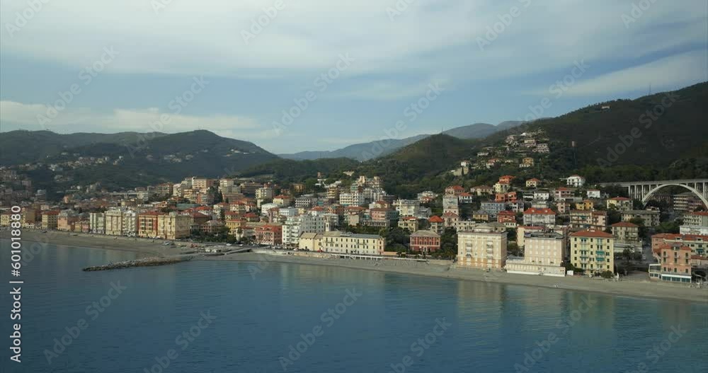Stunning orbiting aerial view of the quaint coastal Italian village town of Varazze, Liguria with calm waters and mountainous background. Stunning orbiting aerial view of the quaint coastal Italian village town of Varazze, Liguria with calm waters and mountainous background.