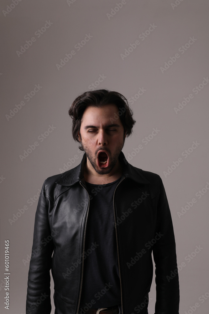 Handsome young man making face grimace isolated on white wall. Vertical mock-up. Handsome young man making face grimace isolated on white wall. Vertical mock-up.