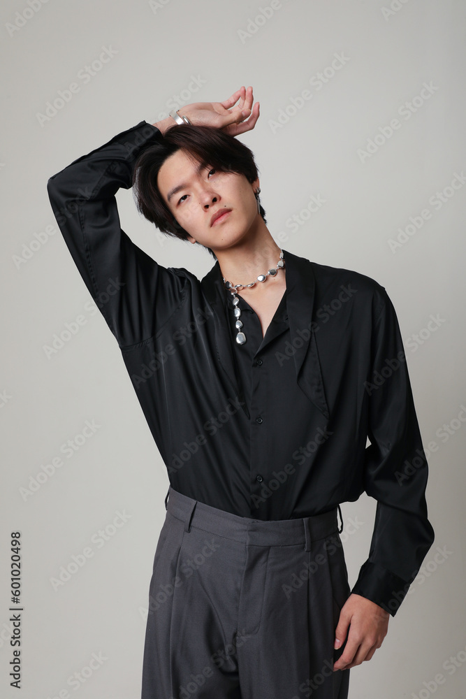 Fototapeta premium Confident young Asian man with calm face expression. Vertical mock-up. Mind set.