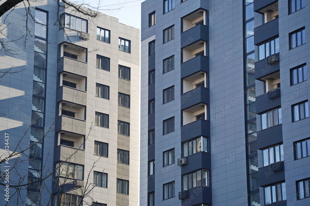 Obraz premium Almaty, Kazakhstan - 12.23.2021 : Multi-storey houses with different windows and balconies in the city center.