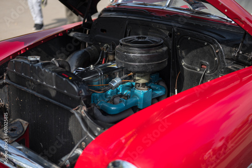 Detail of the large carburetion engine of a classic and historical American car, the red car © Adolf