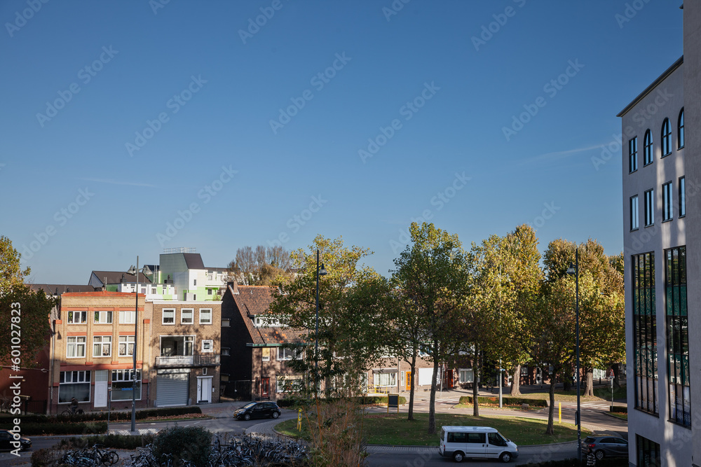 Panorama of a typical suburban dutch street in the city of Heerlen in the netherlands, in Limburg, with houses and residential buildings.