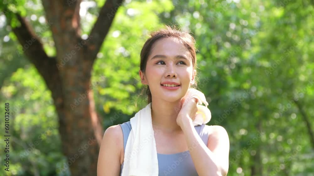 Portrait young asian woman attractive smiling and use white towel resting after workout. Smiling sporty young woman working out outdoors and looking at camera. Healthy lifestyle well being wellness Portrait young asian woman attractive smiling and use white towel resting after workout. Smiling sporty young woman working out outdoors and looking at camera. Healthy lifestyle well being wellness