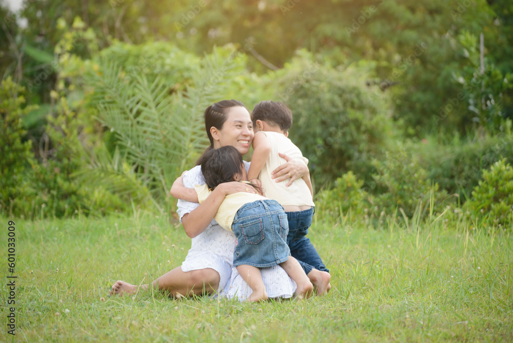 Asian pregnant Mother and Happy son and daughter greeting, proud and hug together. Mom and adorable little Child playing together outdoor at rice field. Mother's day and Happy family Concept. Asian pregnant Mother and Happy son and daughter greeting, proud and hug together. Mom and adorable little Child playing together outdoor at rice field. Mother's day and Happy family Concept.