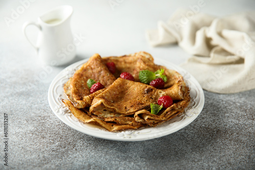 Traditional homemade crepes with raspberry