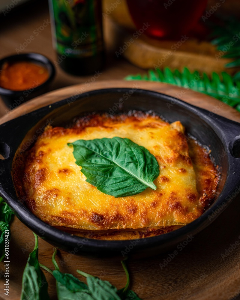 Delicious gourmet lasagna wrap with fresh topping leaf in food table with mediterranean decoration Delicious gourmet lasagna wrap with fresh topping leaf in food table with mediterranean decoration