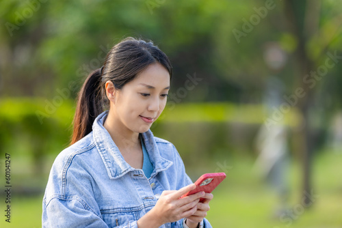 Woman use of mobile phone over the green background