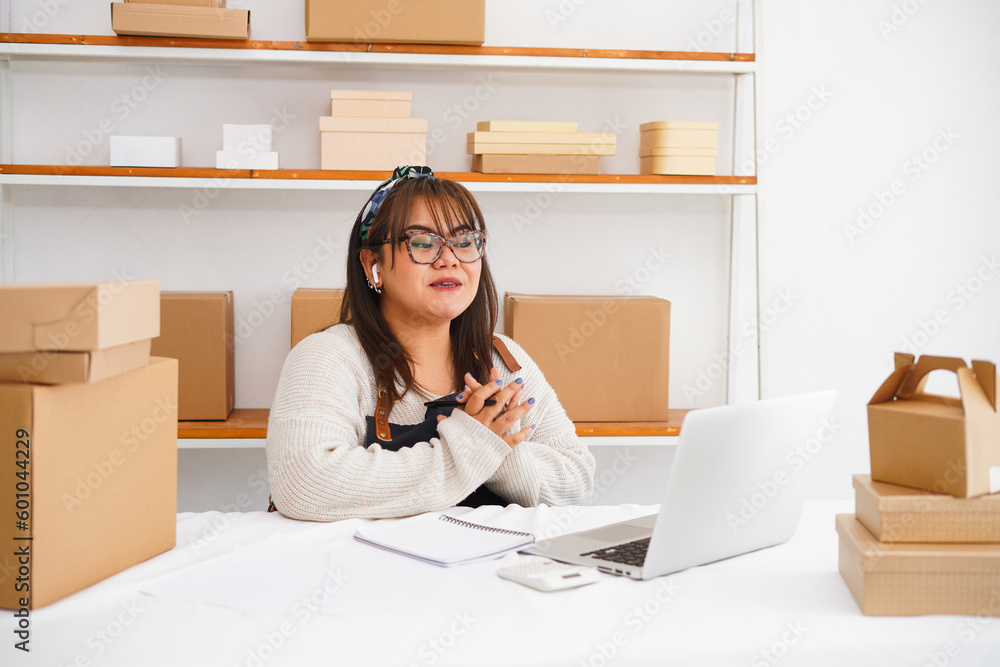 Portrait of an Asian young woman working at the workplace. Startup small business owner, small business entrepreneur delivery concept. Portrait of an Asian young woman working at the workplace. Startup small business owner, small business entrepreneur delivery concept.