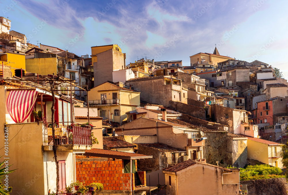 scenic view of historical center of a city with old vintage yellow buildings and houses with orange tiled roof and beautiful blue sky on background