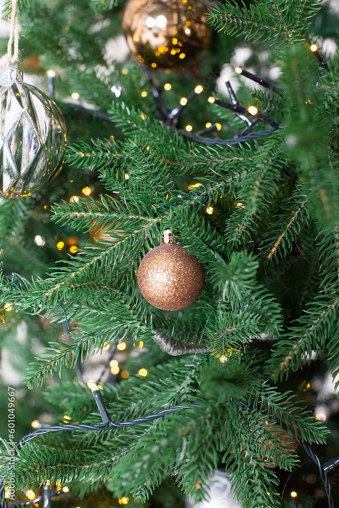 Fototapeta premium The Christmas and New Year's Eve interior of the room is decorated with gifts, garlands and a Christmas tree.