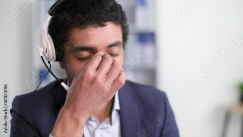 Wallpaper Mural hard work, tired african american man takes off headset and eyeglasses due to fatigue and rubs eyes with hands after working day sitting at table in office Torontodigital.ca