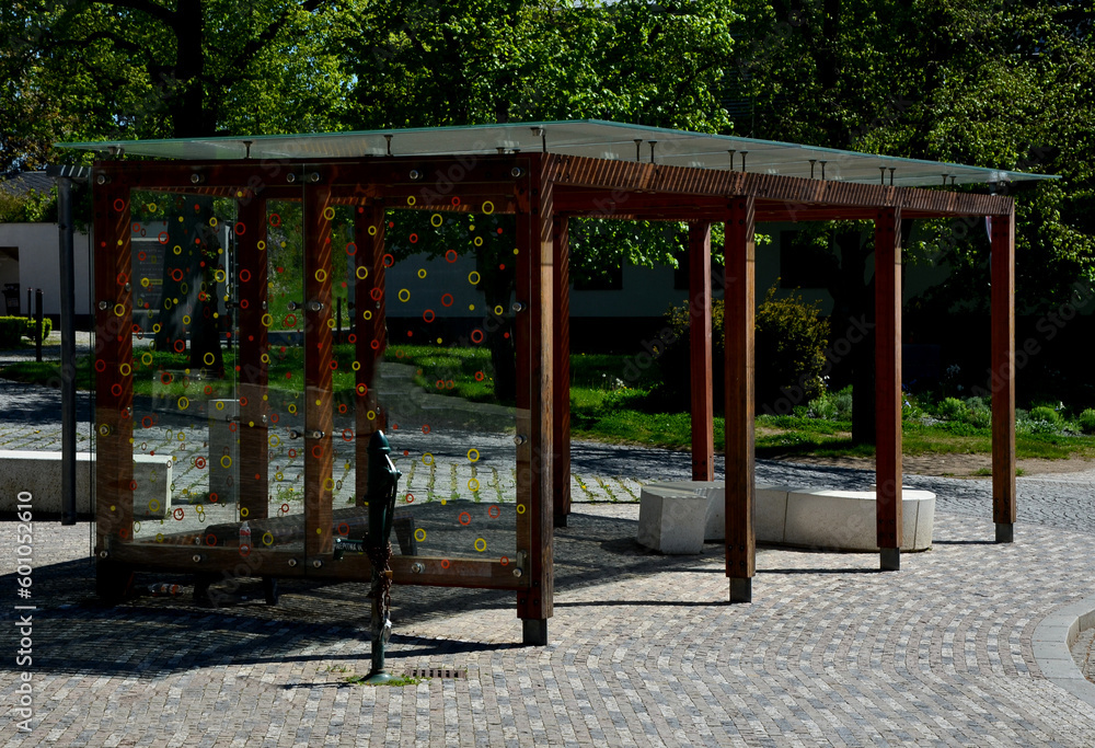 wooden structure of the bus stop, the shelter of the gazebo pergola. the roof and walls are lined with glass. the glass is anchored with stainless steel couplings. ceiling glass is white striped, sun 
