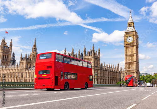 Red bus on Westminster bridge next to Big Ben in London, the UK. photo