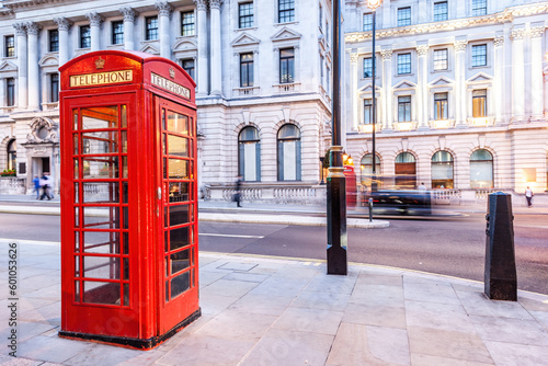 London red telephone booth on city street.