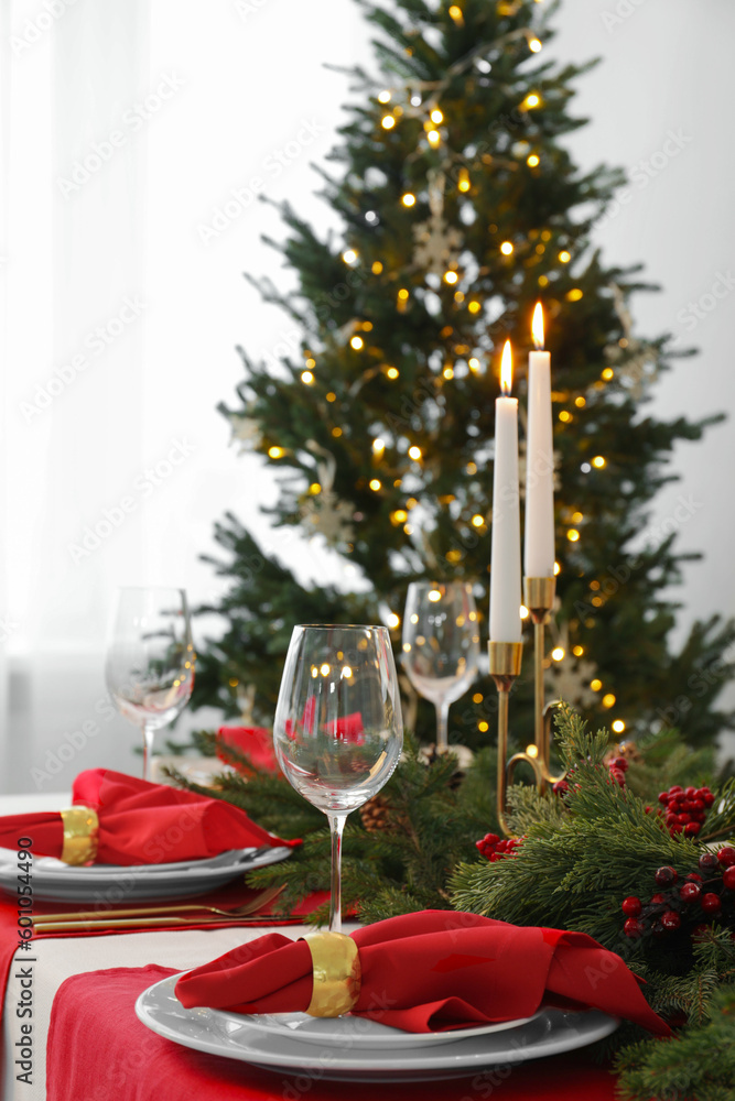 Beautiful table setting with Christmas decor in room Beautiful table setting with Christmas decor in room