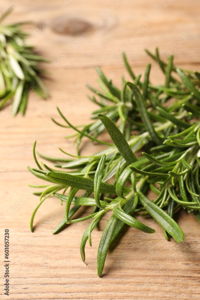 Fresh green rosemary on wooden table, closeup Fresh green rosemary on wooden table, closeup