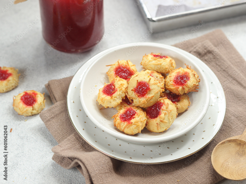 Homemade thumb print cookies filled with strawberry jam and grated cheese Homemade thumb print cookies filled with strawberry jam and grated cheese