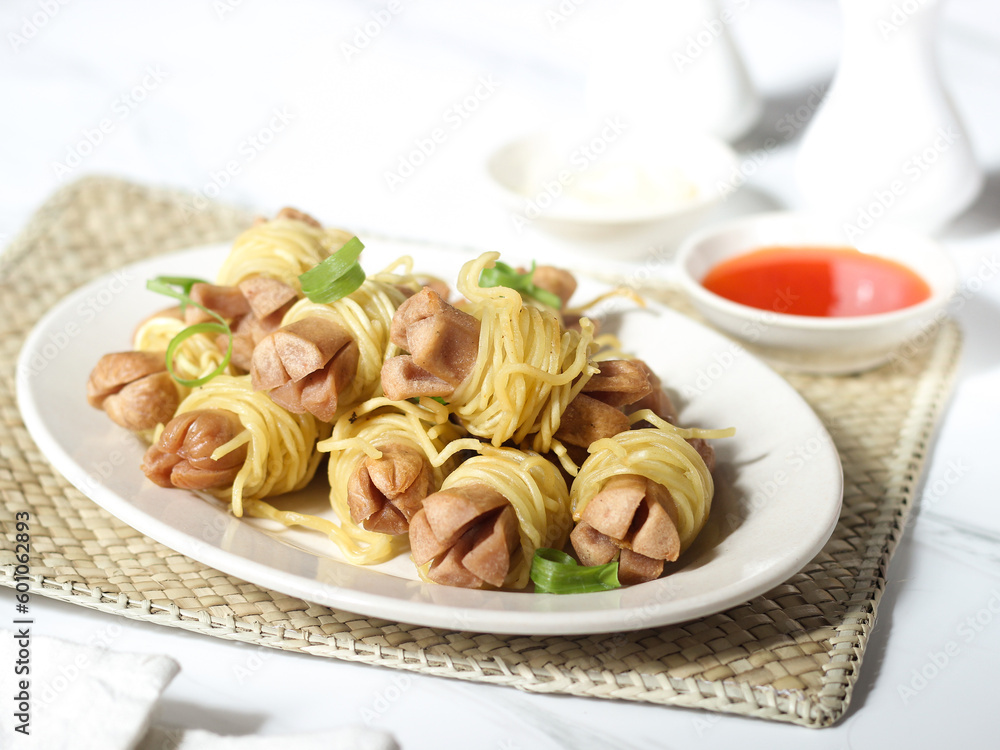 Sosis Ayam Gulung Mie or Chicken Sausage Rolled in Noodles. Cooked by frying and usually served with sauce and mayonnaise. One of the popular street food in Indonesia