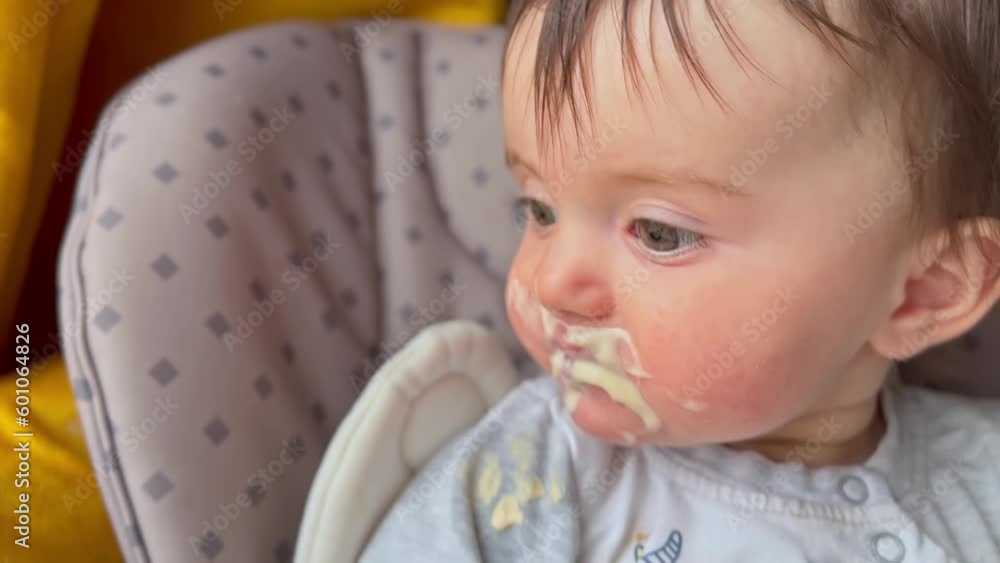 dirty baby eats. baby a girl eating yogurt milk food close-up stained her mouth face. happy family healthy baby food concept. lifestyle little baby girl learning to eat her mouth stained with yogurt dirty baby eats. baby a girl eating yogurt milk food close-up stained her mouth face. happy family healthy baby food concept. lifestyle little baby girl learning to eat her mouth stained with yogurt
