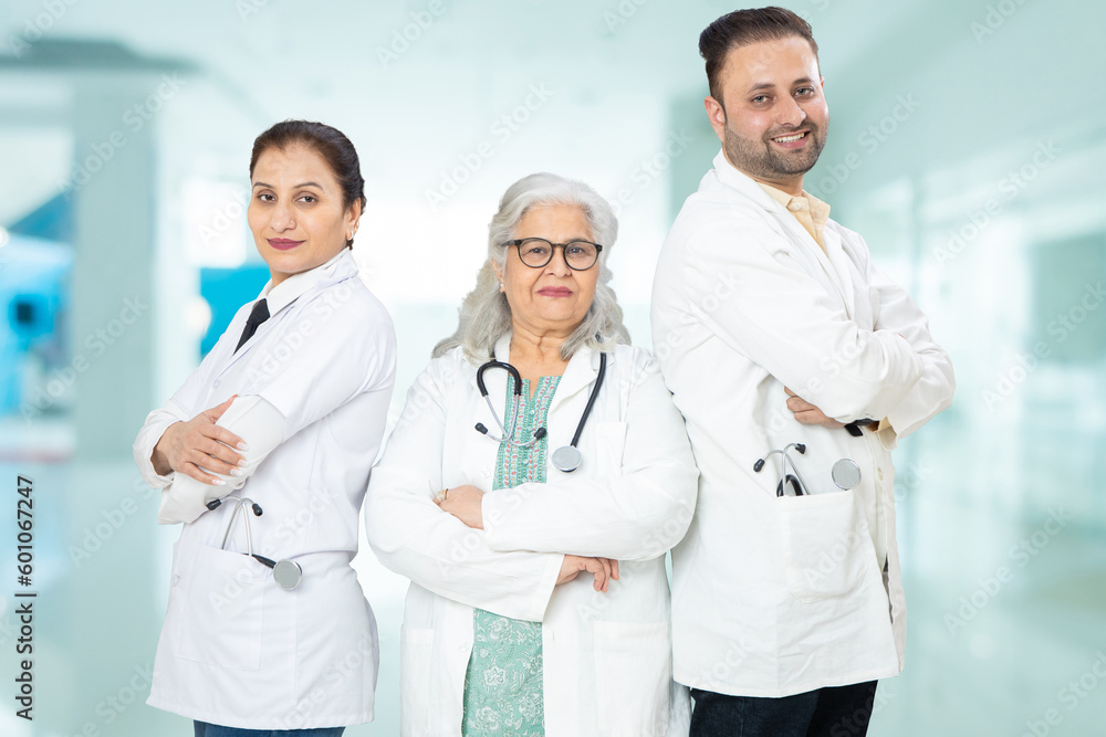 Team of indian doctors standing standing cross arms at hospital, healthcare and medical concept. Team of indian doctors standing standing cross arms at hospital, healthcare and medical concept.