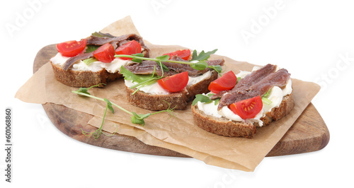 Delicious bruschettas with anchovies, tomatoes, microgreens and cream cheese on white background