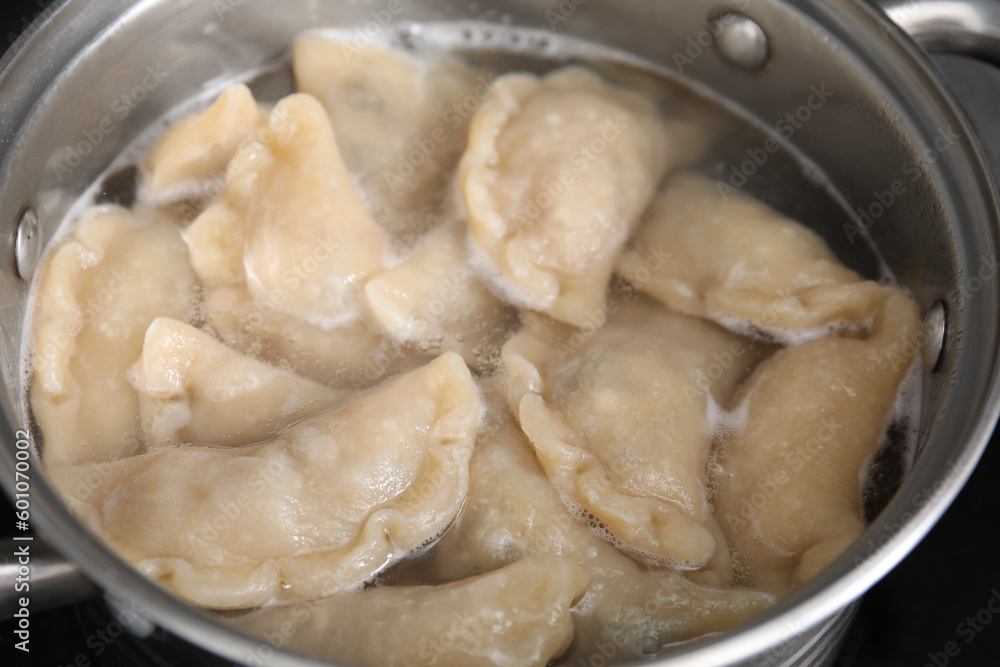 Boiling delicious dumplings (varenyky) in pot, closeup Boiling delicious dumplings (varenyky) in pot, closeup