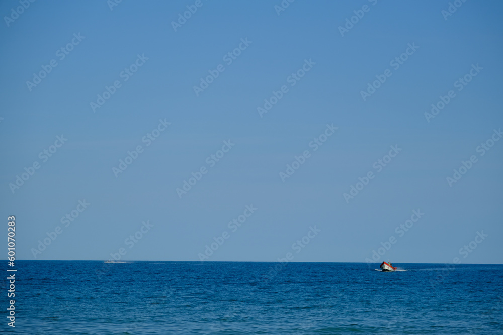 Seascape with Boat and Skyline on Deep Blue Sea