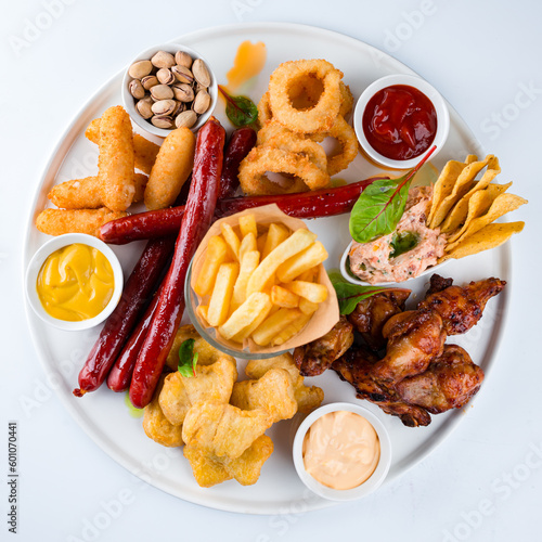 French fries, breaded mozzarella cheese, chicken legs, onion rings coated with breadcrumbs, sausages, nuts and sauces.