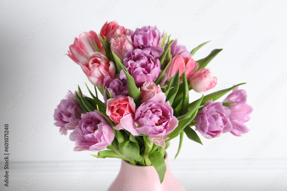 Beautiful bouquet of colorful tulip flowers on white background, closeup