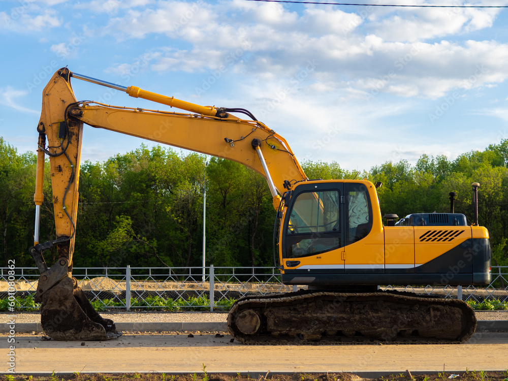 Yellow excavator on the road Yellow excavator on the road