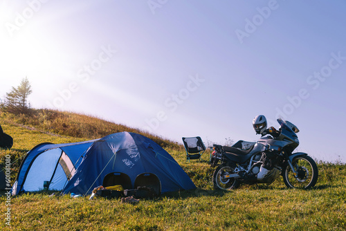 Motorcycle traveling concept  camping with a blue tent  scenic nature landscape with mountains  Copy space. Ukraine.