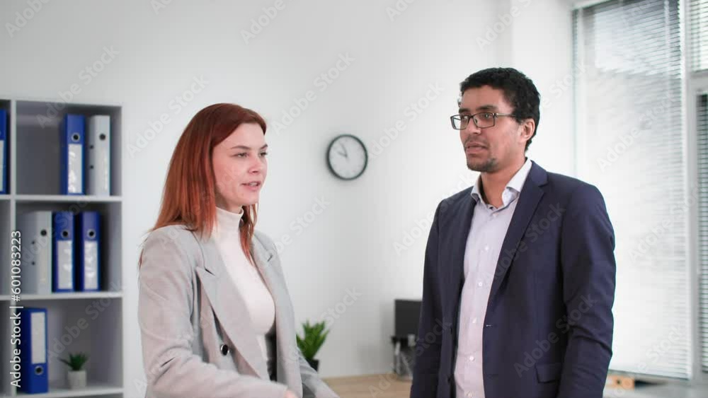 coffee break, young woman talking to african american male employee in office coffee break, young woman talking to african american male employee in office