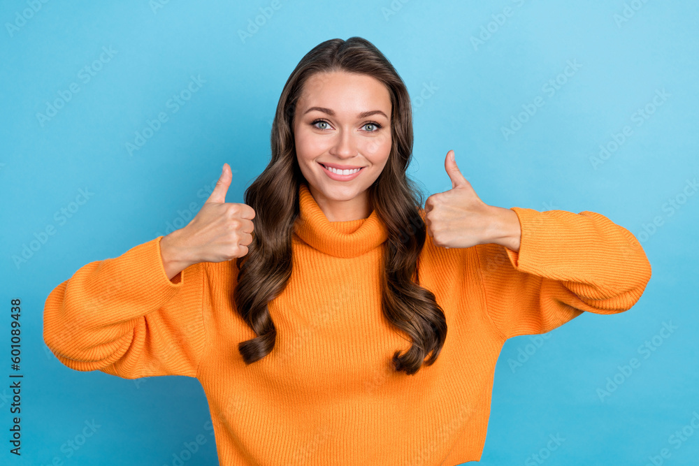 Photo of confident cool lady wear knitted pullover showing two fingers up isolated blue color background Photo of confident cool lady wear knitted pullover showing two fingers up isolated blue color background