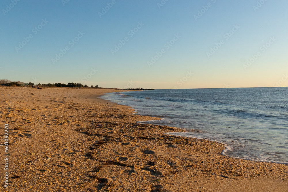 This picture was taken at Sunset beach in Cape May New Jersey. The color of the sand seems to glow orange in this image. The beautiful ocean and the waves crashing into the shore. This picture was taken at Sunset beach in Cape May New Jersey. The color of the sand seems to glow orange in this image. The beautiful ocean and the waves crashing into the shore.
