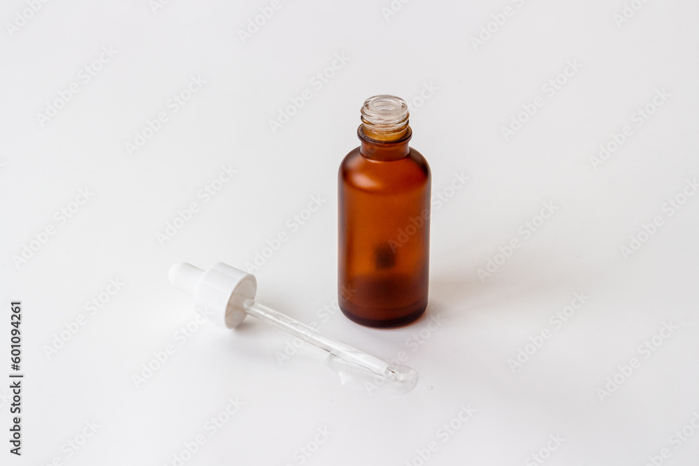 Essential serum oil in dropper bottle. Cosmetic products background Essential serum oil in dropper bottle. Cosmetic products background