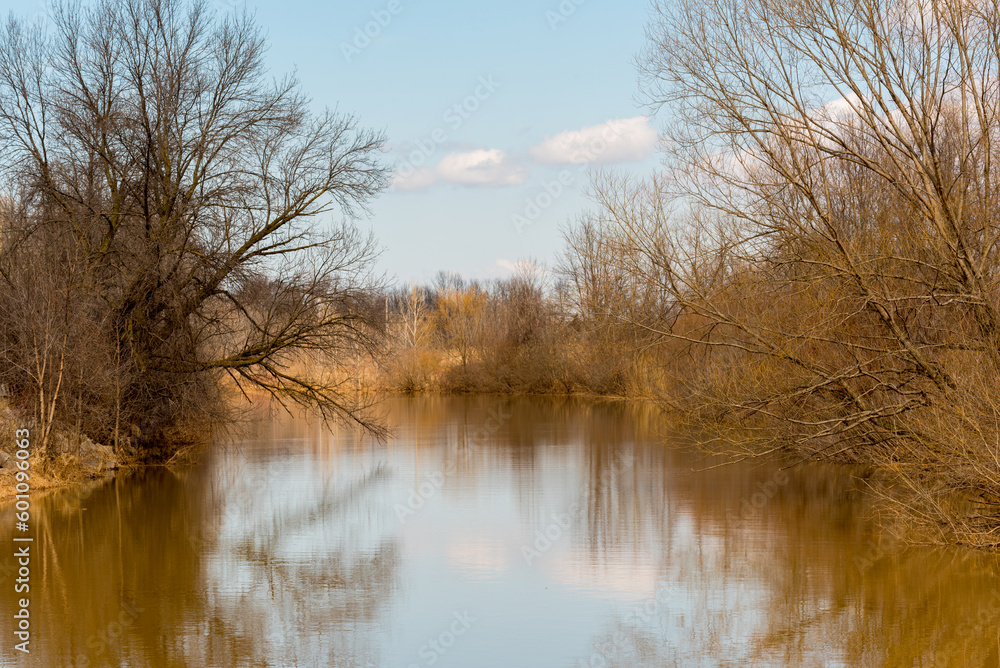 A Blue Sky Reflected On The River In Spring