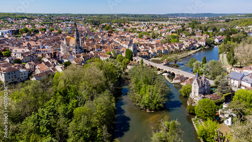 Aerial view of the medieval town of Moret-sur-Loing in Seine et Marne, France - Stone bridge spanning the river Loing towards the Burgundy Gate tower next to Our Lady of the Nativity Church photo