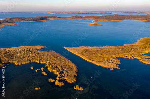 Fototapeta Naklejka Na Ścianę i Meble -  Masurian Lake District in Poland - beautifiul drone landscape, blue water, forest, autumn sunset time, Mazury great lakes