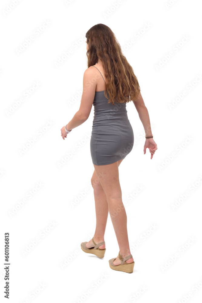 side and back view of young girl with short dress walking on white background side and back view of young girl with short dress walking on white background