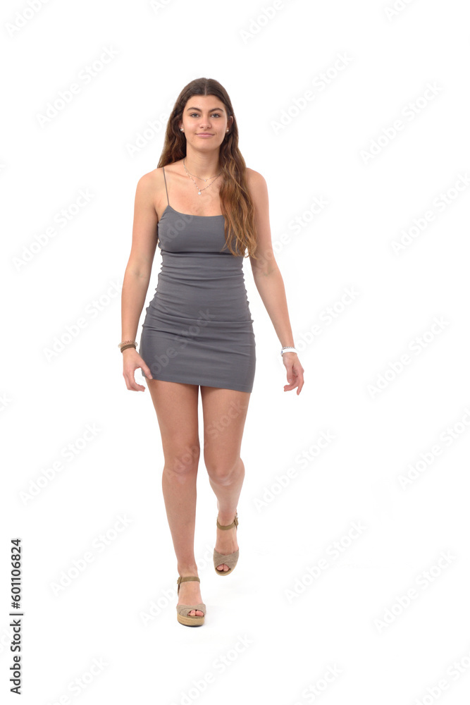 front view of young girl with short dress walking on white background front view of young girl with short dress walking on white background