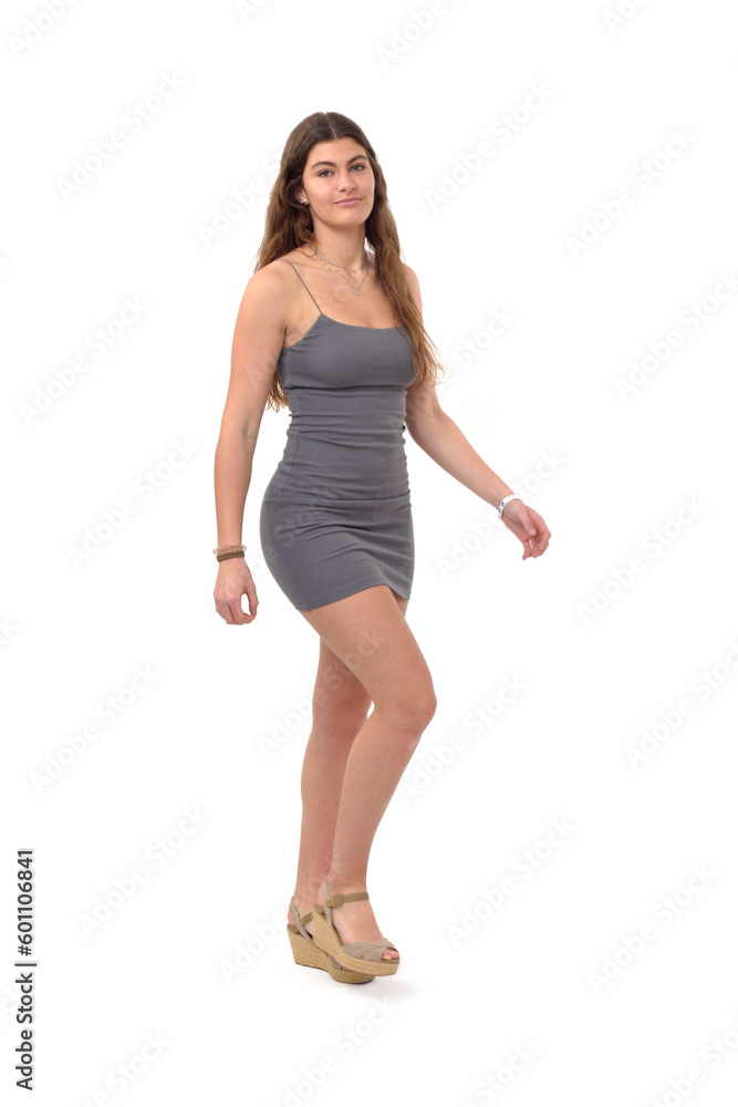 side view of young girl with short dress walking and looking at camera on white background side view of young girl with short dress walking and looking at camera on white background