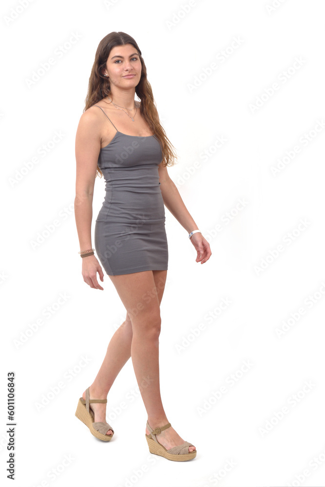 side view of young girl with short dress walking on white background side view of young girl with short dress walking on white background