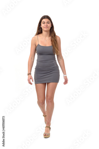 front view of young girl with short dress walking on white background