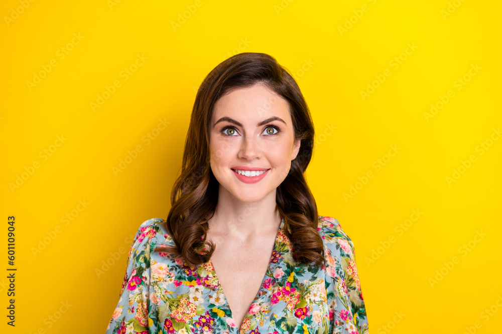 Photo of stunning positive girl beaming smile look up above empty space isolated on yellow color background Photo of stunning positive girl beaming smile look up above empty space isolated on yellow color background