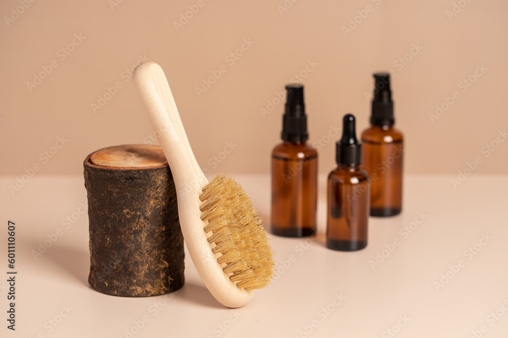 Massage brushes, natural cosmetic in glass bottle and towel. Eco-friendly items. Biodegradable personal care products.