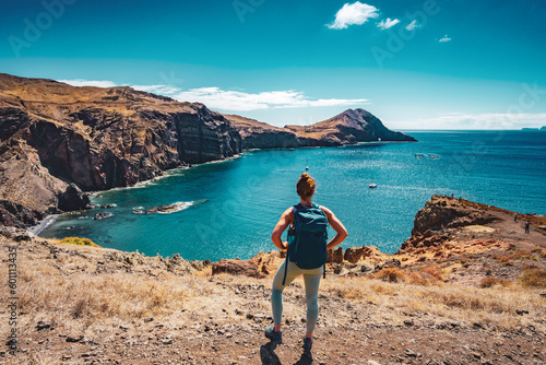 Athletic woman enjoys the view of the beautiful foothills of the island from a hiking trail. São Lourenço, Madeira Island, Portugal, Europe.