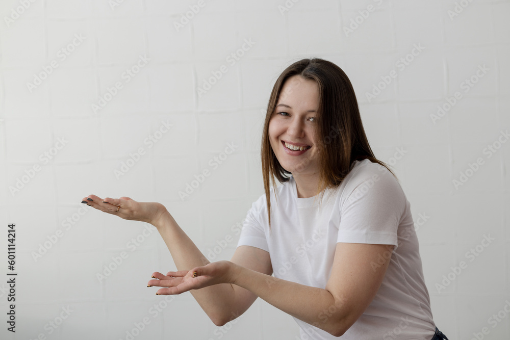 Young beautiful chubby girl posing for the camera making figures with her hands